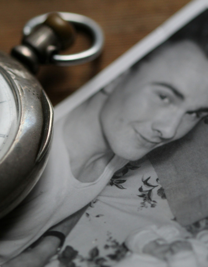 Vintage photo of a man with a pocket watch laid partially across it